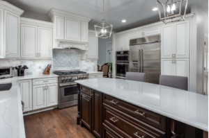 An updated kitchen with a large kitchen island and white cabinets.